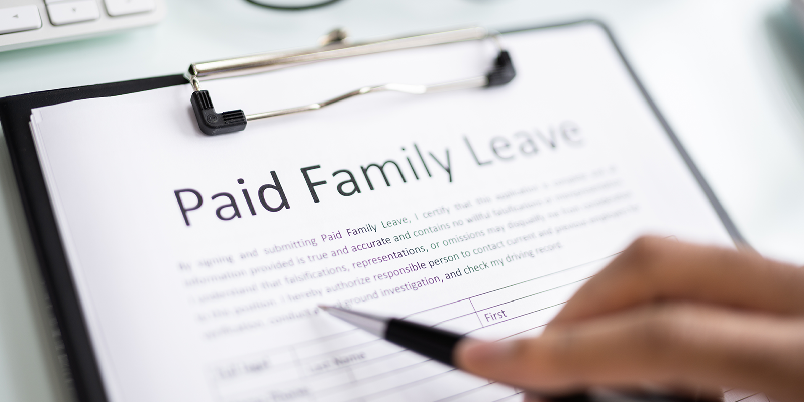 Filling out a Paid Family Leave Document. Photo Credit: Andrey Popov/ Getty Image